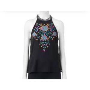 About a girl size M embroidered front lace collar racer back tank top.